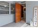 Cozy entryway featuring a rustic wood door and convenient access to the half bath at 5138 Andrea Blvd, Orlando, FL 32807