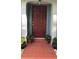 Close-up of a welcoming front door with decorative plants and tiled porch at 5138 Andrea Blvd, Orlando, FL 32807