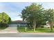 Charming single story home featuring a manicured lawn, lush landscaping, and an attached garage at 5138 Andrea Blvd, Orlando, FL 32807