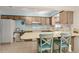 Bright kitchen with wooden cabinets, breakfast bar, and view to the outdoor space at 5138 Andrea Blvd, Orlando, FL 32807