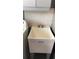 Practical laundry area with a large utility sink and a white tiled backsplash at 5138 Andrea Blvd, Orlando, FL 32807