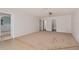 Large, carpeted living room with neutral paint, ceiling fan and multiple doorways at 5138 Andrea Blvd, Orlando, FL 32807