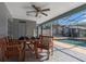 Cozy covered patio with dining furniture and a view of the sparkling pool, perfect for outdoor entertaining at 5138 Andrea Blvd, Orlando, FL 32807