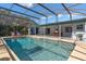 Expansive screened-in pool area with a covered patio and ample space for lounging and dining at 5138 Andrea Blvd, Orlando, FL 32807