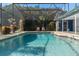 Backyard swimming pool is surrounded by a screened-in enclosure for relaxed outdoor enjoyment at 5138 Andrea Blvd, Orlando, FL 32807