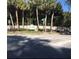 Entrance to Dover Manor, featuring signage, manicured landscaping, and mature palm trees at 5138 Andrea Blvd, Orlando, FL 32807