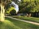 Street view of the house featuring mature trees and a well-kept lawn at 5138 Andrea Blvd, Orlando, FL 32807