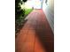 Exterior walkway with paving stones lined with landscaping pebbles and verdant greenery at 5138 Andrea Blvd, Orlando, FL 32807