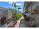 Side walkway with a garden bench and vibrant green foliage adding charm to the exterior at 5138 Andrea Blvd, Orlando, FL 32807