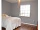 Bright bedroom with wood floors and a large window at 9130 Dollanger Ct, Orlando, FL 32819
