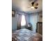 Bedroom with blue walls and a ceiling fan at 9130 Dollanger Ct, Orlando, FL 32819