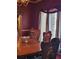 Elegant dining room with ornate chairs, wood table, and large windows with curtains at 9130 Dollanger Ct, Orlando, FL 32819