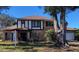 Brick, two-story house with mature landscaping and a large tree in the front yard at 9130 Dollanger Ct, Orlando, FL 32819