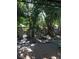 Peaceful garden with stone patio, lush foliage, and seating area at 9130 Dollanger Ct, Orlando, FL 32819