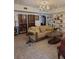 Spacious living room with built-in shelving, comfortable seating, and a large chandelier at 9130 Dollanger Ct, Orlando, FL 32819