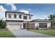 Two-story home with modern design, stone accents, and a three-car garage at 9441 Golden Laurel Ln, Orlando, FL 32827