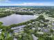Aerial view of community near lake featuring buildings, parking, and lush landscape at 105 Northlake Dr # 105, Sanford, FL 32773