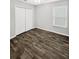 Bright bedroom with wood-look floors and double door closet at 105 Northlake Dr # 105, Sanford, FL 32773