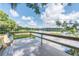 Wooden deck overlooking a serene lake with lush greenery at 105 Northlake Dr # 105, Sanford, FL 32773