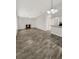 Open living room featuring a fireplace and wood-look tile floors at 105 Northlake Dr # 105, Sanford, FL 32773
