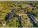 An aerial view of a single Gathering home with mature trees and landscaping at 1208 Old Apopka Rd, Apopka, FL 32703