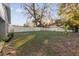 This home boasts a large back yard with mature trees and a white fence at 1208 Old Apopka Rd, Apopka, FL 32703