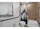 This bathroom features a tiled shower/tub combo, a toilet, and a sink with a granite countertop at 1208 Old Apopka Rd, Apopka, FL 32703