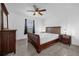 This bedroom features tile floors, a ceiling fan, natural lighting, and closet space at 1208 Old Apopka Rd, Apopka, FL 32703