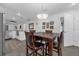 Dining area featuring modern lighting, wood-look tile floors, and easy access to the kitchen at 1208 Old Apopka Rd, Apopka, FL 32703