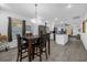 Open dining area featuring modern lighting, wood-look tile floors, and easy access to the kitchen at 1208 Old Apopka Rd, Apopka, FL 32703
