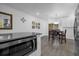 Cozy dining area with wood-look tile floors, modern lighting, and views of the backyard at 1208 Old Apopka Rd, Apopka, FL 32703