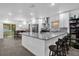 Bright kitchen boasts granite countertops, stainless steel appliances, modern cabinets, and a breakfast bar at 1208 Old Apopka Rd, Apopka, FL 32703