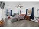 This bedroom features tile floors, a ceiling fan, natural lighting, and ample space at 1208 Old Apopka Rd, Apopka, FL 32703