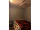Small bedroom with Buccaneers blanket, and a glass desk at 1320 S Oleander Ave, Sanford, FL 32771
