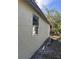 Exterior side view featuring light colored brick, window, and mature trees at 1320 S Oleander Ave, Sanford, FL 32771