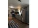 A modern kitchen with stainless steel appliances, light grey cabinets, a backsplash, and wood floors at 1320 S Oleander Ave, Sanford, FL 32771