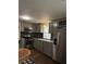 A modern kitchen with stainless steel appliances, light grey cabinets, a backsplash, and wood floors at 1320 S Oleander Ave, Sanford, FL 32771
