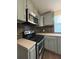 Kitchen featuring grey cabinets, stainless steel appliances, and tile backsplash at 1320 S Oleander Ave, Sanford, FL 32771