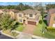 Two-story house with a brown roof, brick driveway, and well-manicured lawn at 1918 Arden Oaks Dr, Ocoee, FL 34761