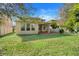 Large backyard with green grass and a patio area at 1918 Arden Oaks Dr, Ocoee, FL 34761