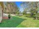 Spacious backyard with lush green grass and mature trees at 1918 Arden Oaks Dr, Ocoee, FL 34761