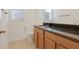 Bathroom with granite countertop and single sink vanity at 1918 Arden Oaks Dr, Ocoee, FL 34761