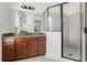 Bathroom with granite countertop, large mirror and walk-in shower at 1918 Arden Oaks Dr, Ocoee, FL 34761