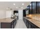 Modern kitchen with granite countertops and dark wood cabinets at 1918 Arden Oaks Dr, Ocoee, FL 34761
