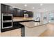 Spacious kitchen with granite island, dark cabinetry, and stainless steel appliances at 1918 Arden Oaks Dr, Ocoee, FL 34761