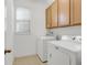 Convenient laundry room with washer, dryer, and overhead cabinets at 1918 Arden Oaks Dr, Ocoee, FL 34761