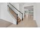 A staircase with a black railing, leading to an open living area at 1918 Arden Oaks Dr, Ocoee, FL 34761