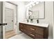 Bathroom features a double vanity, quartz countertops and modern lighting at 2337 Worthington Rd, Maitland, FL 32751