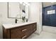 Bathroom with double vanity, quartz countertops and blue tiled shower at 2337 Worthington Rd, Maitland, FL 32751