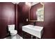 This bathroom features a toilet and sink with stylish gold mirror and light fixtures at 2337 Worthington Rd, Maitland, FL 32751